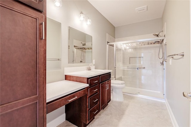 bathroom with toilet, a shower stall, and vanity