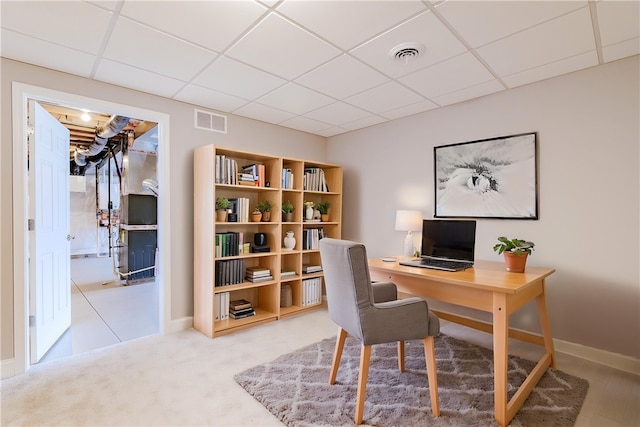 office with visible vents, a paneled ceiling, and baseboards