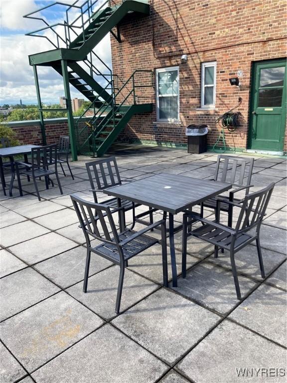 731 W Fry Unit 7G, Buffalo, NY 14222 - view of patio featuring stairs and outdoor dining space