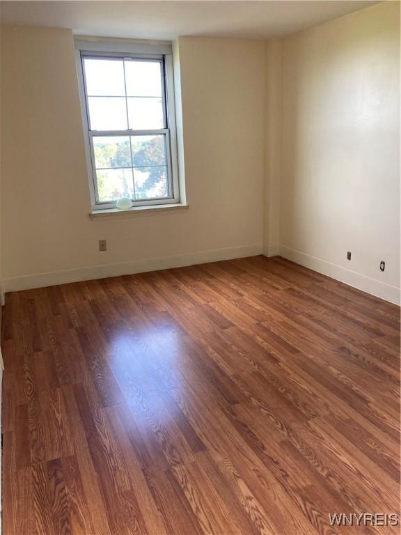 731 W Fry Unit 7G, Buffalo, NY 14222 - empty room featuring baseboards and wood finished floors