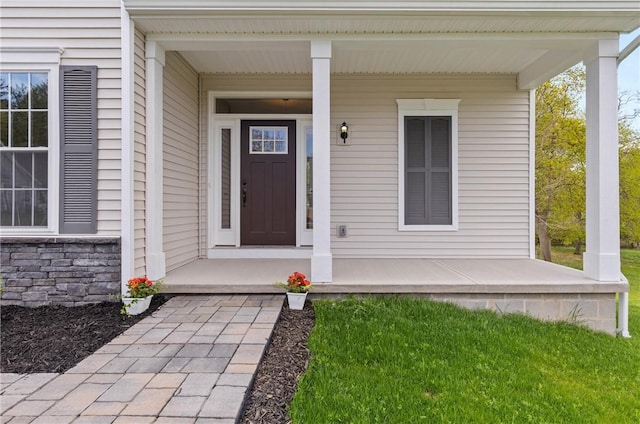 entrance to property with covered porch and stone siding