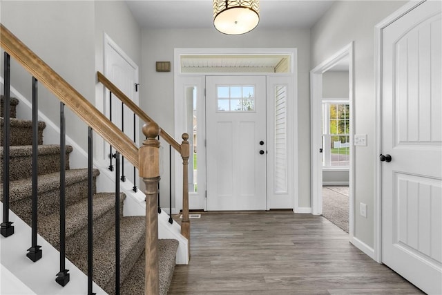 foyer entrance featuring stairway, baseboards, plenty of natural light, and wood finished floors