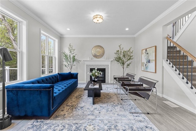 living area with crown molding, stairs, wood finished floors, baseboards, and recessed lighting