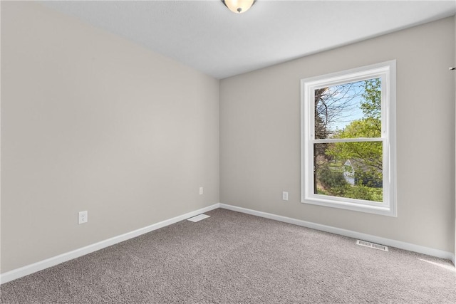 carpeted empty room with baseboards and visible vents