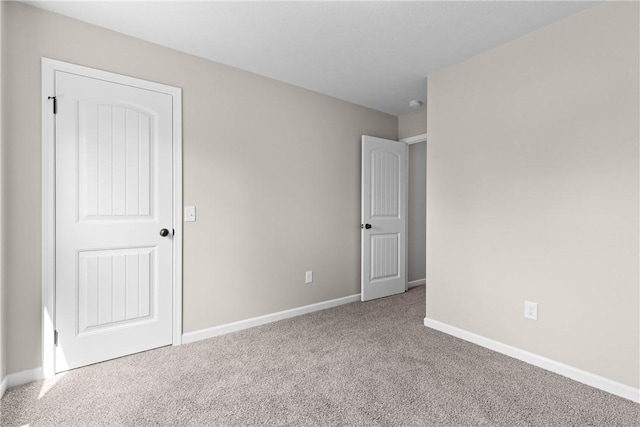 unfurnished bedroom featuring baseboards and carpet