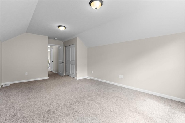 bonus room featuring carpet floors, baseboards, and vaulted ceiling