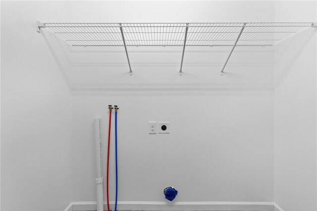 laundry area featuring baseboards, laundry area, hookup for an electric dryer, and hookup for a washing machine