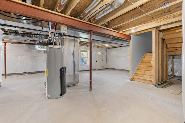 basement featuring stairs and water heater