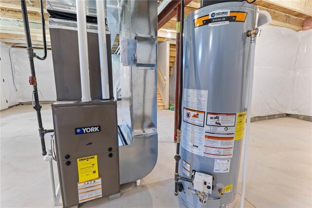 utility room featuring heating unit and gas water heater