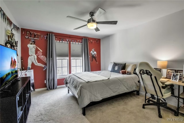 carpeted bedroom featuring baseboards and ceiling fan