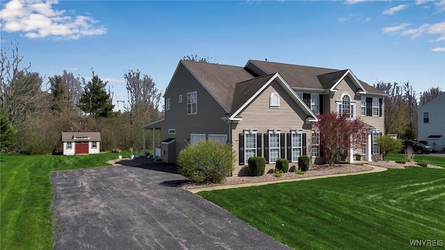 view of front of house featuring a storage shed, an outdoor structure, and a front yard