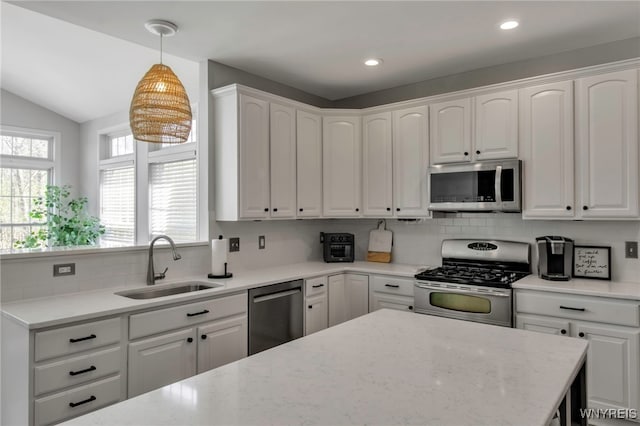kitchen featuring a sink, appliances with stainless steel finishes, tasteful backsplash, and white cabinets