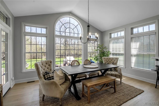 sunroom / solarium with visible vents, a notable chandelier, and a healthy amount of sunlight