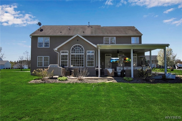 rear view of house with a yard, a patio, and ceiling fan
