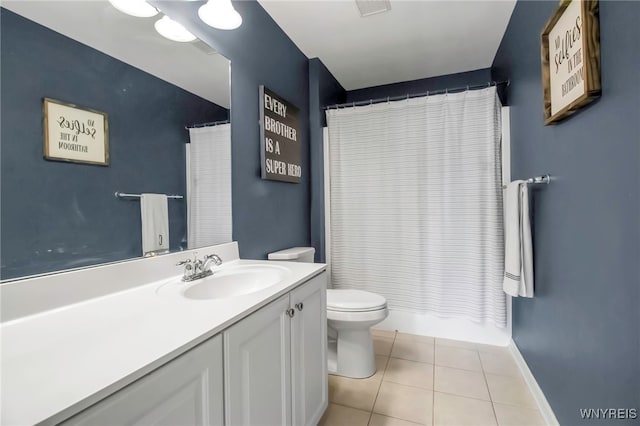 bathroom with curtained shower, vanity, tile patterned floors, baseboards, and toilet