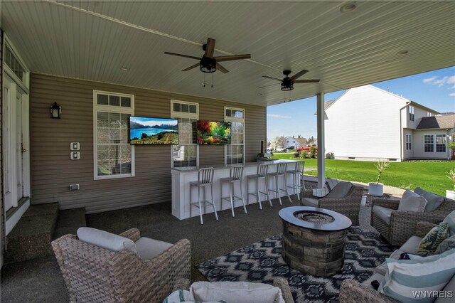 view of patio featuring outdoor dry bar, a ceiling fan, and an outdoor fire pit