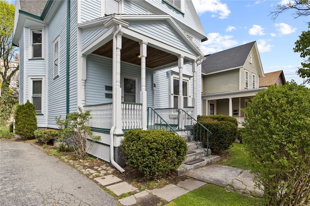 view of exterior entry with covered porch