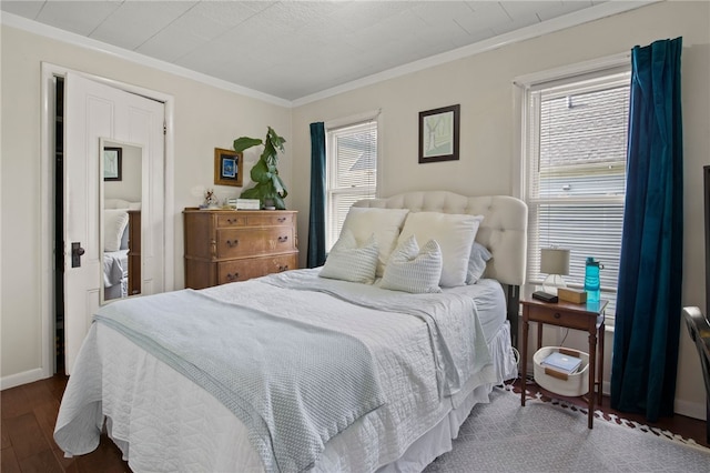 bedroom with crown molding and wood finished floors