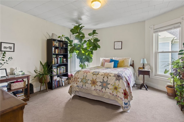 carpeted bedroom featuring baseboards