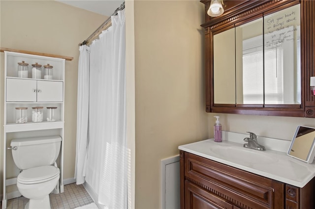 bathroom with tile patterned flooring, curtained shower, toilet, and vanity
