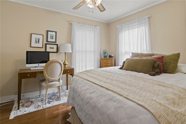 bedroom featuring baseboards, ornamental molding, ceiling fan, and wood finished floors