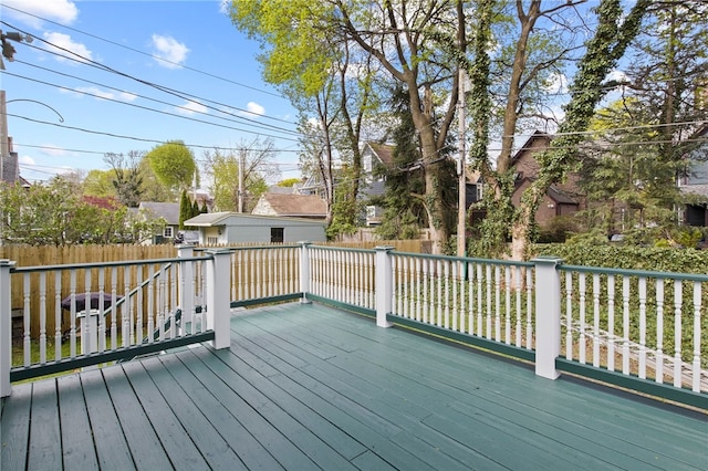 wooden deck with a fenced backyard