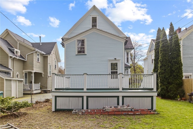 back of house with a yard and a deck