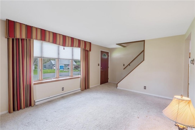 unfurnished living room featuring carpet floors, baseboards, baseboard heating, and stairway
