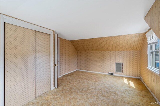 bonus room featuring wallpapered walls and visible vents