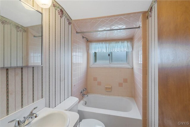 full bathroom with a sink, toilet, and shower / washtub combination