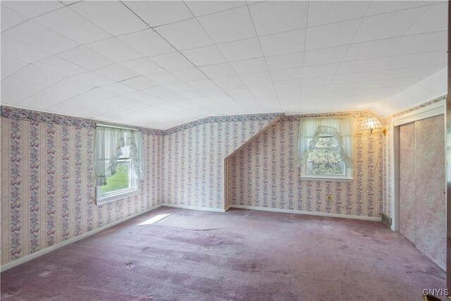 bonus room featuring carpet and wallpapered walls