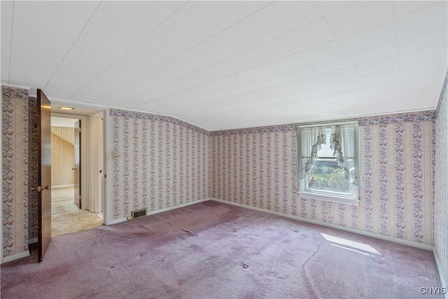 additional living space with visible vents, carpet flooring, and wallpapered walls