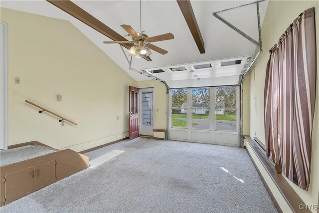 unfurnished living room with vaulted ceiling with beams, light carpet, and a ceiling fan