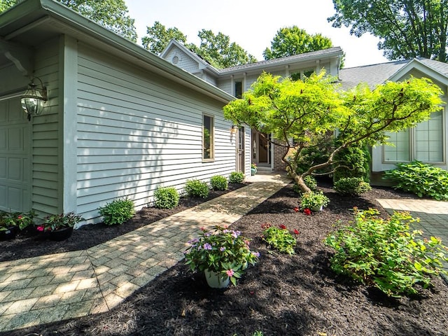 back of house featuring a garage