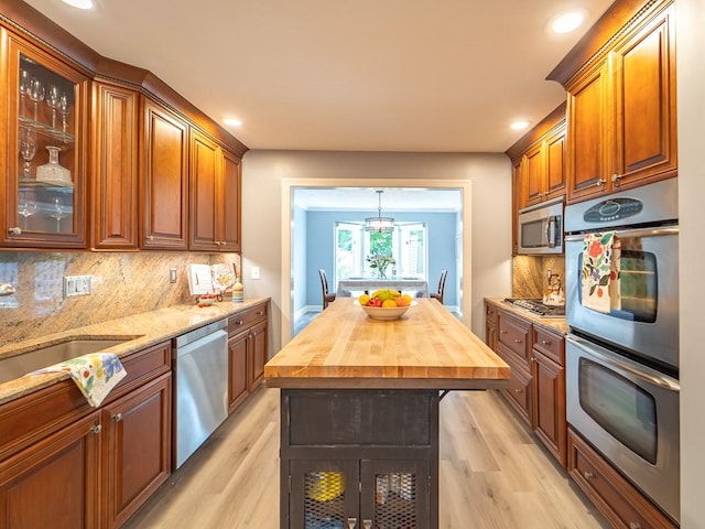 kitchen featuring appliances with stainless steel finishes, wooden counters, recessed lighting, and light wood-style flooring