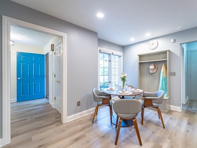 dining room featuring recessed lighting, baseboards, and light wood-type flooring