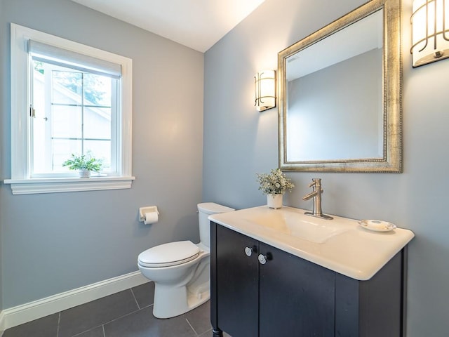 bathroom featuring tile patterned floors, baseboards, vanity, and toilet