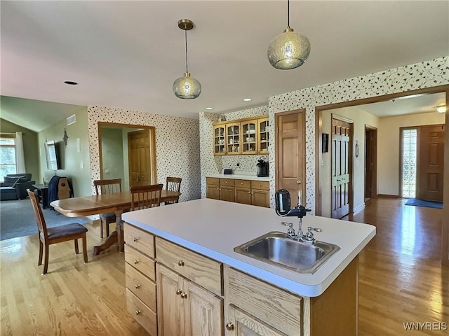 kitchen featuring a healthy amount of sunlight, open floor plan, and wallpapered walls