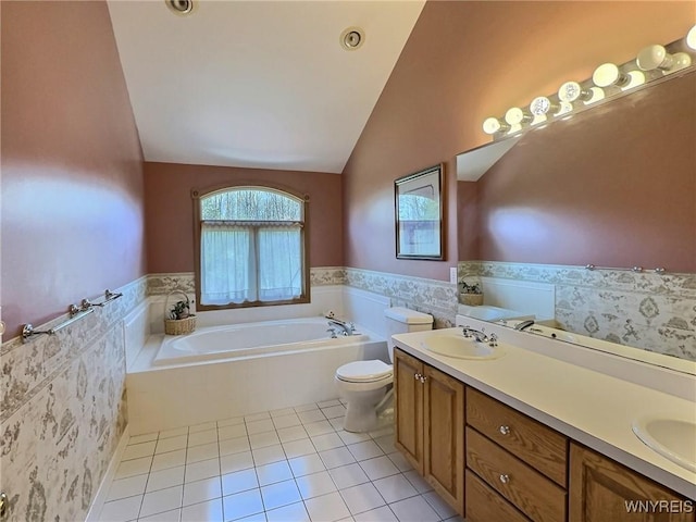full bathroom with lofted ceiling, wainscoting, a bath, a sink, and double vanity