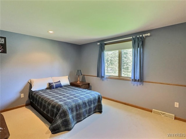 carpeted bedroom with visible vents, baseboards, and recessed lighting