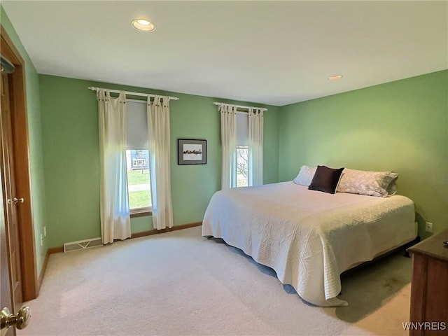 bedroom with baseboards, recessed lighting, visible vents, and carpet