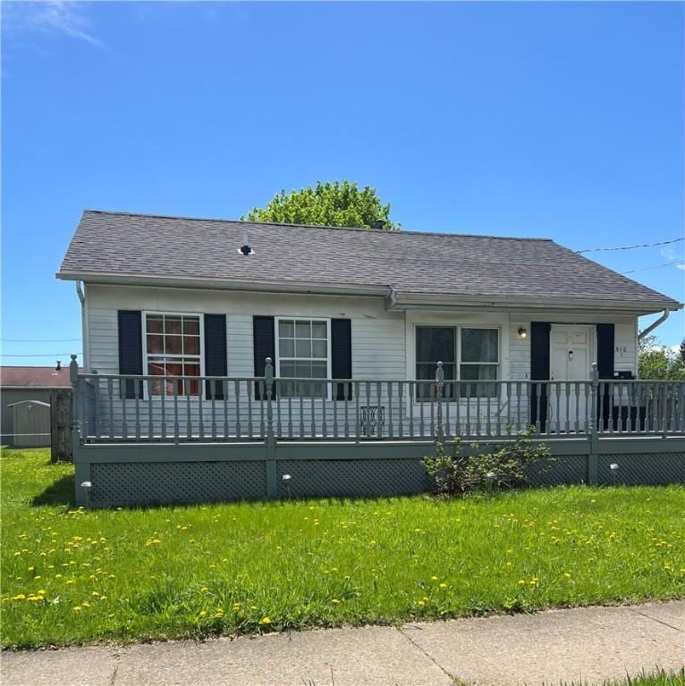 510 Harper St, Elmira-City, NY 14901 - view of front facade with roof with shingles, a wooden deck, and a front yard