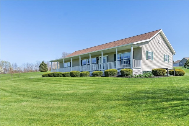 back of house with a yard and covered porch
