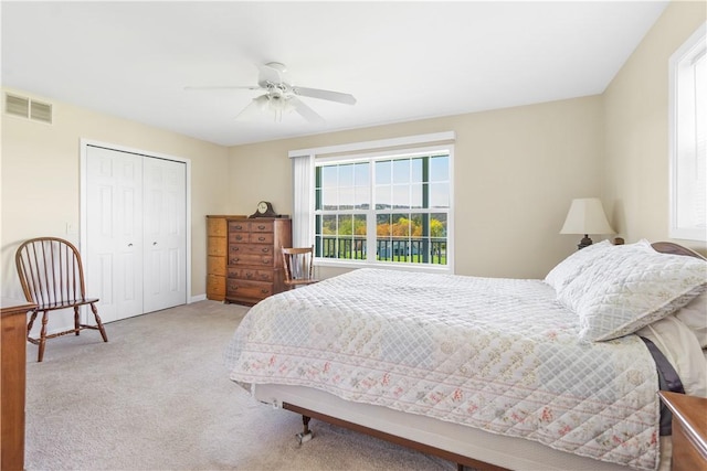 bedroom featuring ceiling fan, a closet, carpet flooring, and visible vents