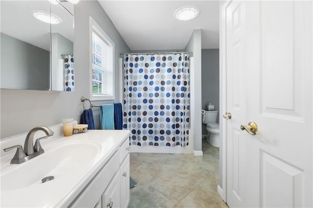 bathroom featuring vanity, tile patterned floors, toilet, and curtained shower