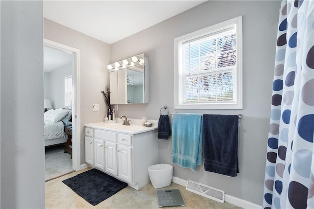 full bathroom featuring visible vents, tile patterned flooring, vanity, baseboards, and connected bathroom