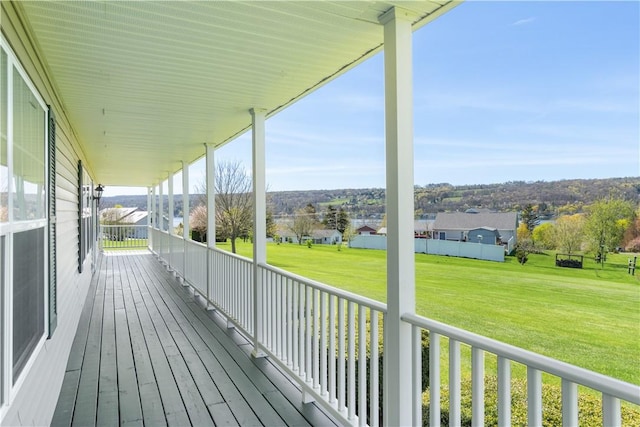 deck with a lawn and a residential view