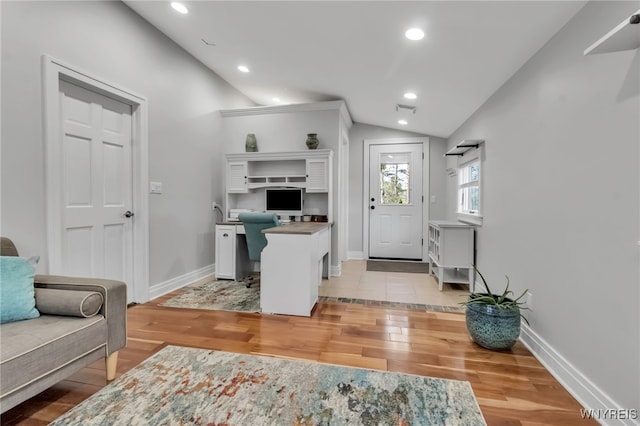 office with recessed lighting, baseboards, lofted ceiling, and light wood-type flooring