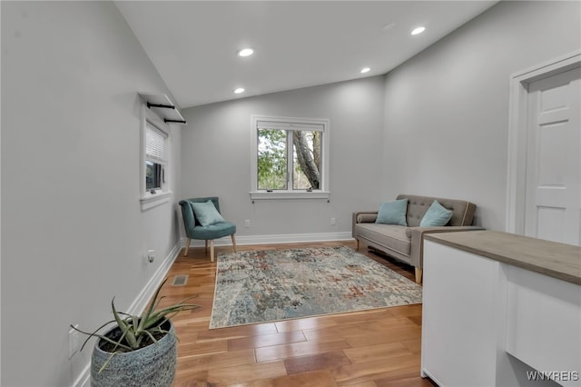 living area featuring recessed lighting, baseboards, light wood finished floors, and lofted ceiling