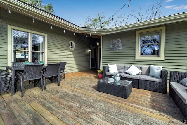 deck featuring outdoor lounge area and outdoor dining space
